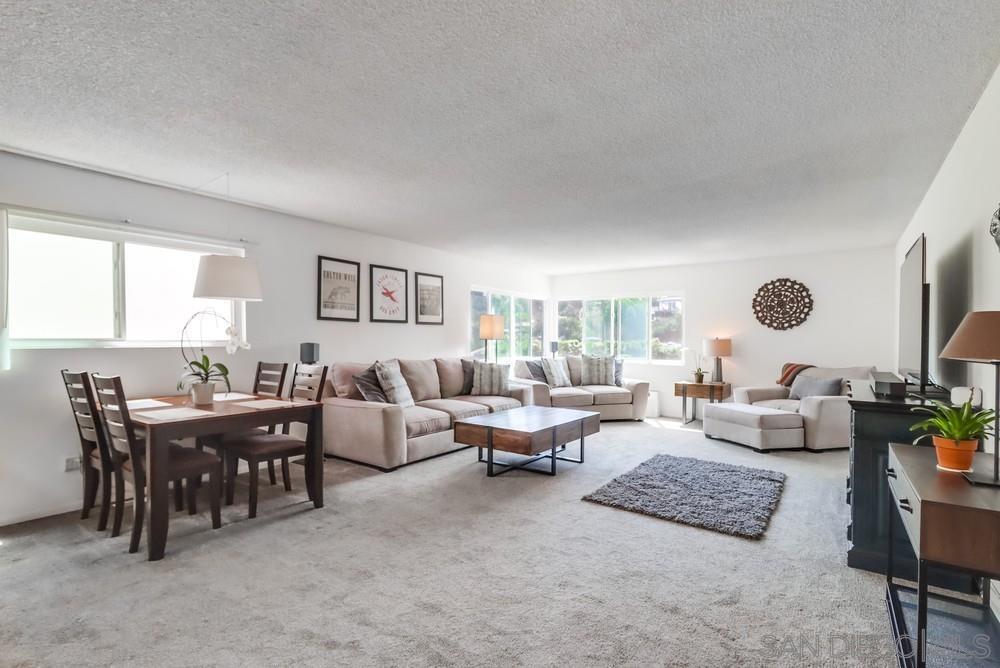 a living room with lots of furniture and a large window