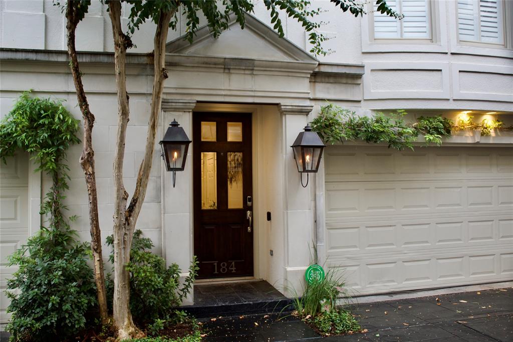 a front view of a house with plants