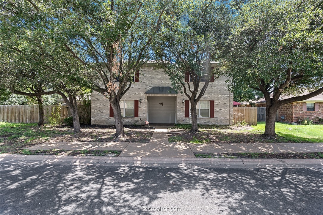 a view of a house with a tree in the background