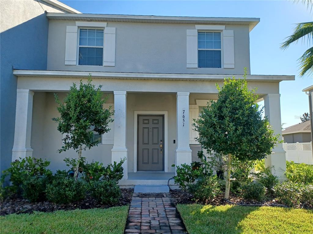 a front view of a house with garden