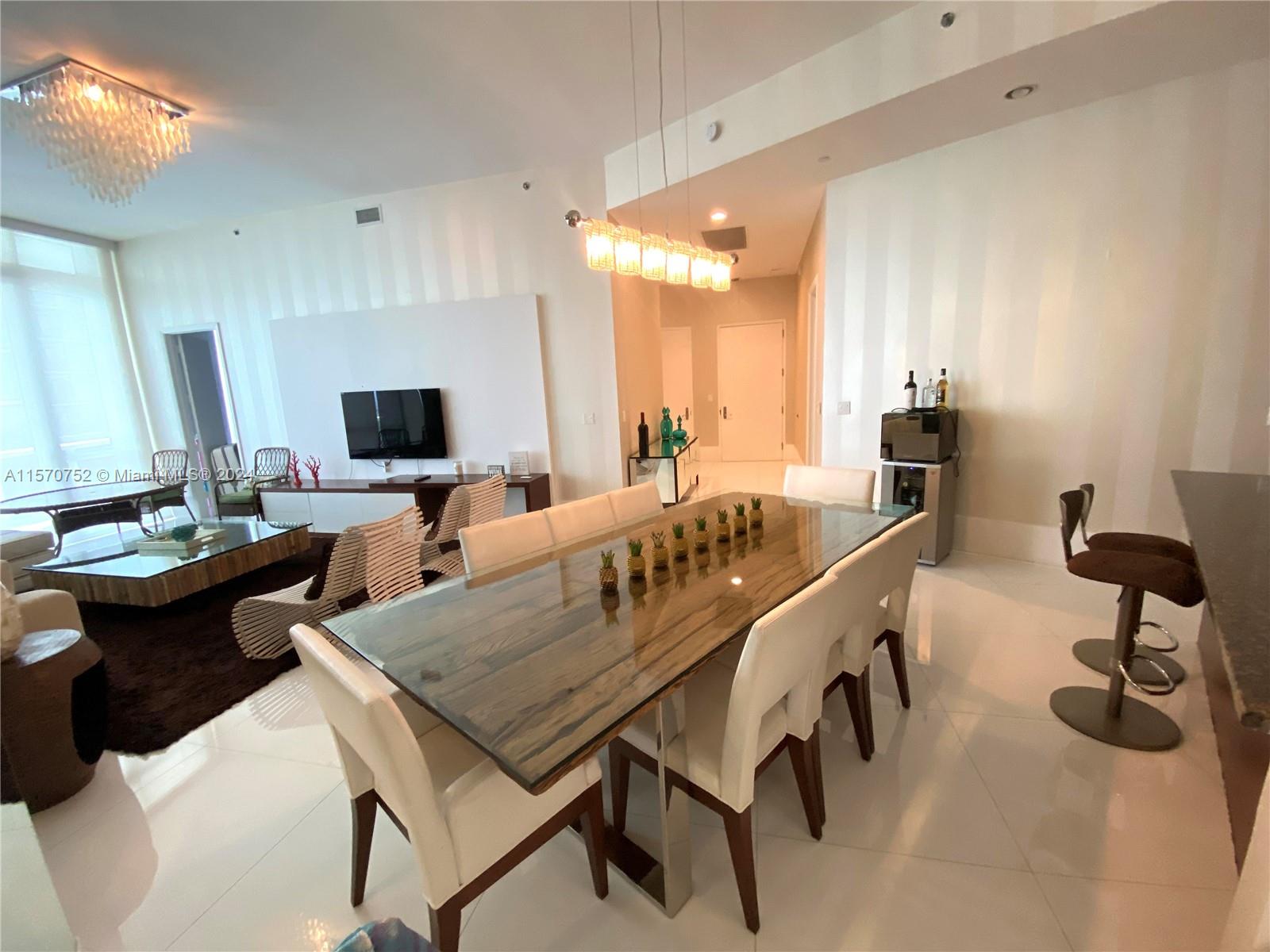 a kitchen with a table chairs stove and cabinets