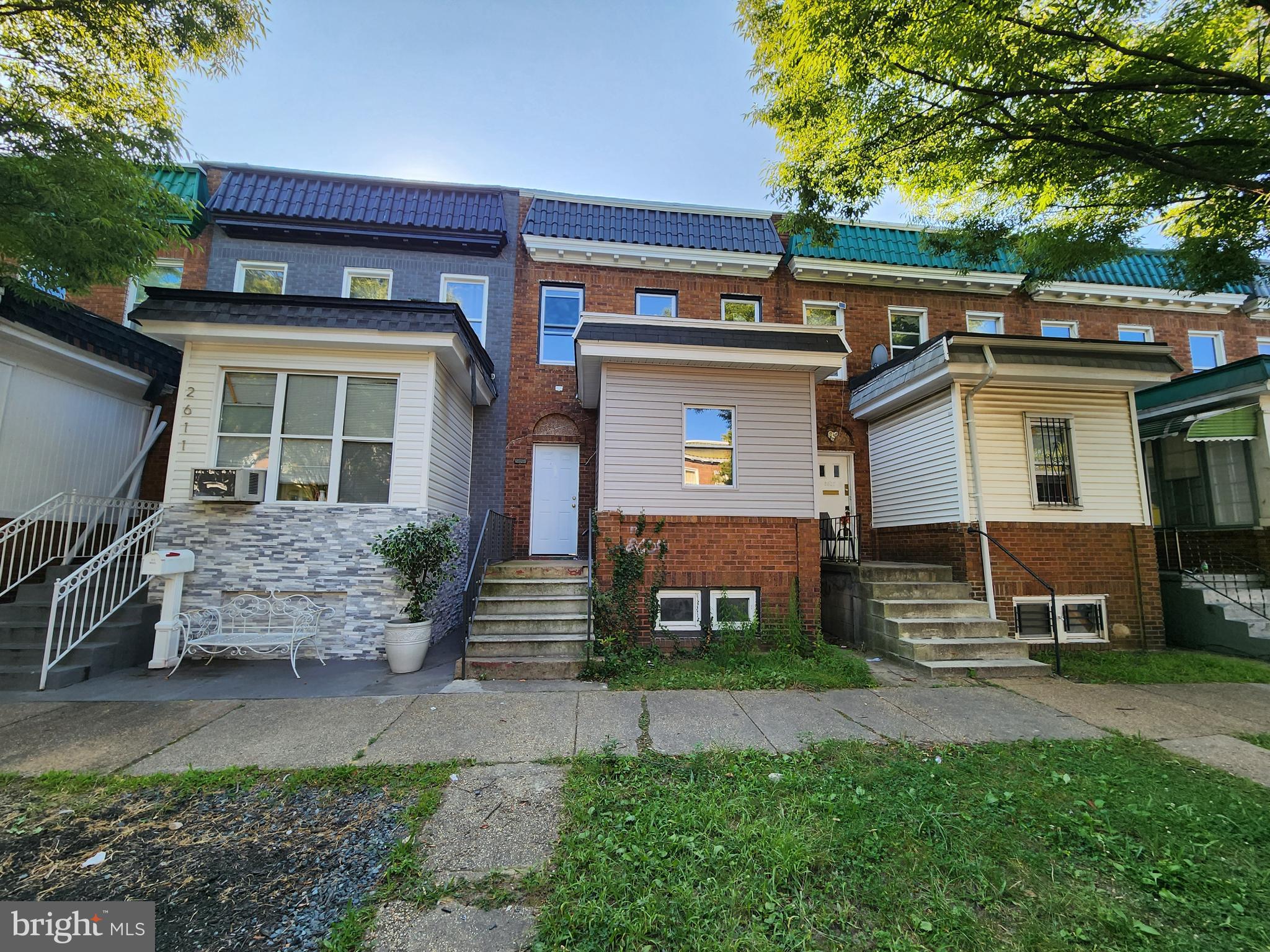 a front view of a house with garden and parking