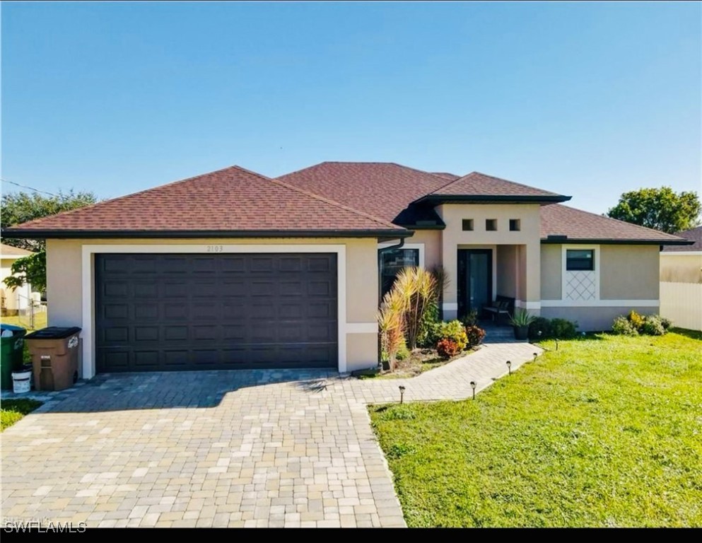 a front view of a house with a yard