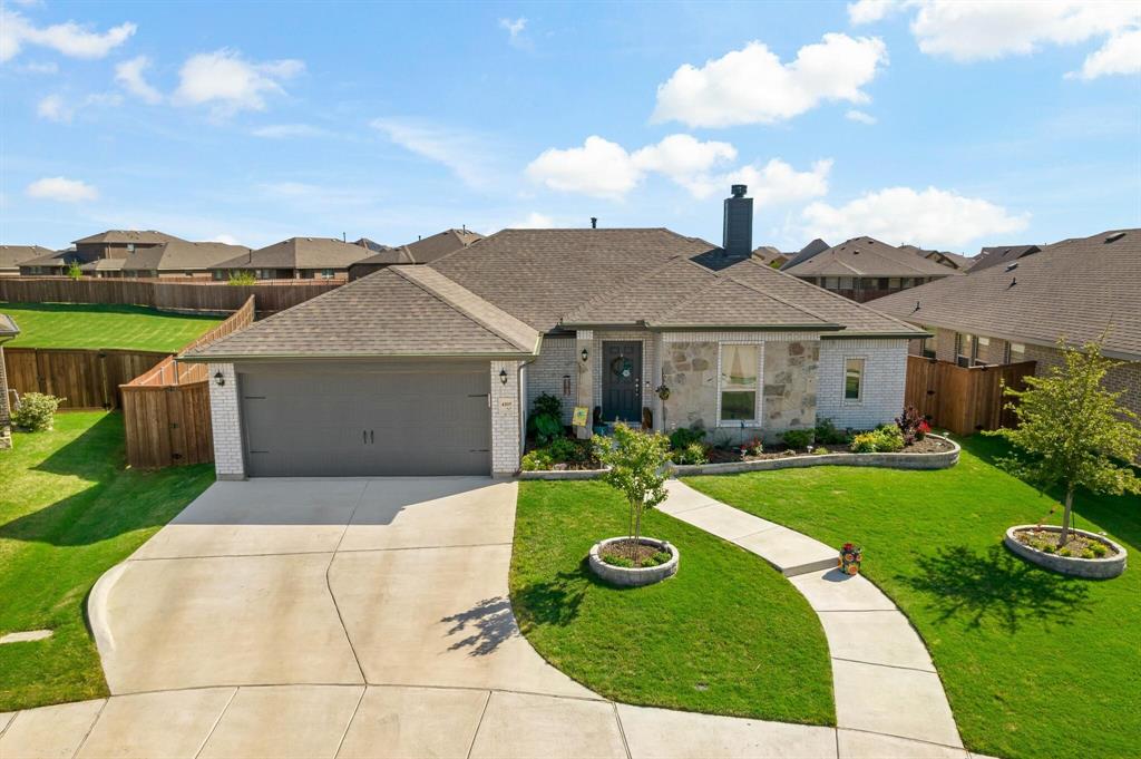 a view of a house with yard and a garden