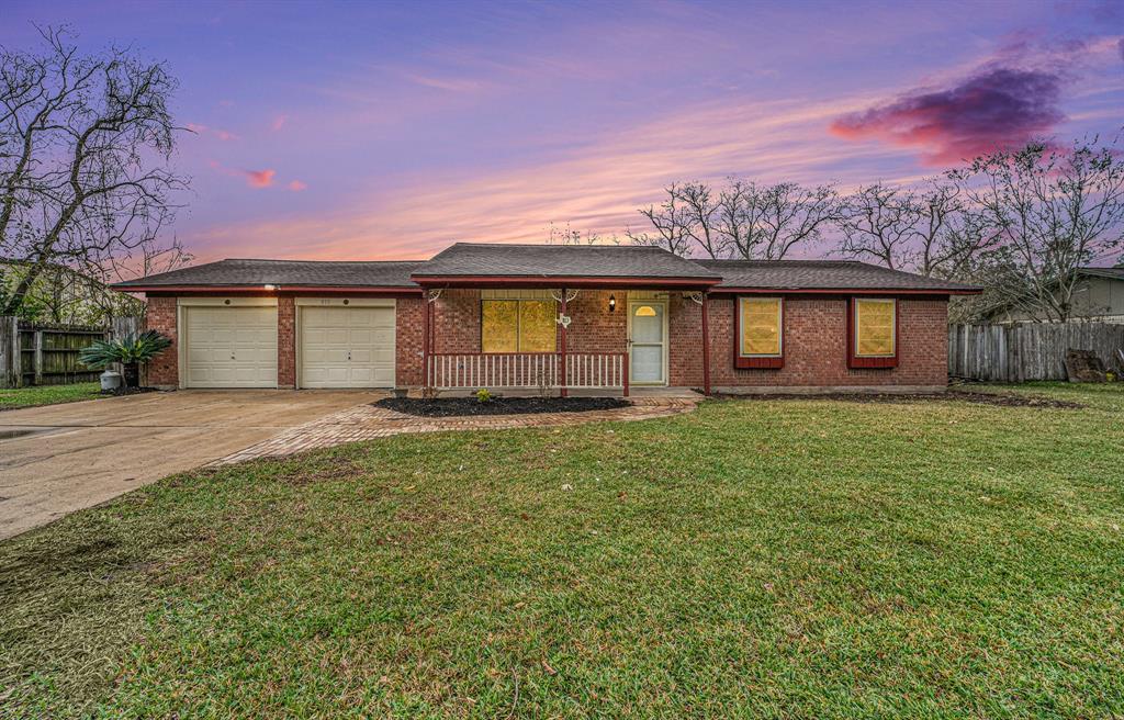 Charming single-story brick home with a two-car garage, spacious front yard, and inviting porch. Perfect for those seeking a cozy and functional space.