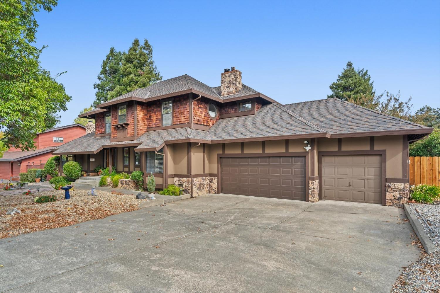 a front view of a house with a yard and a garage