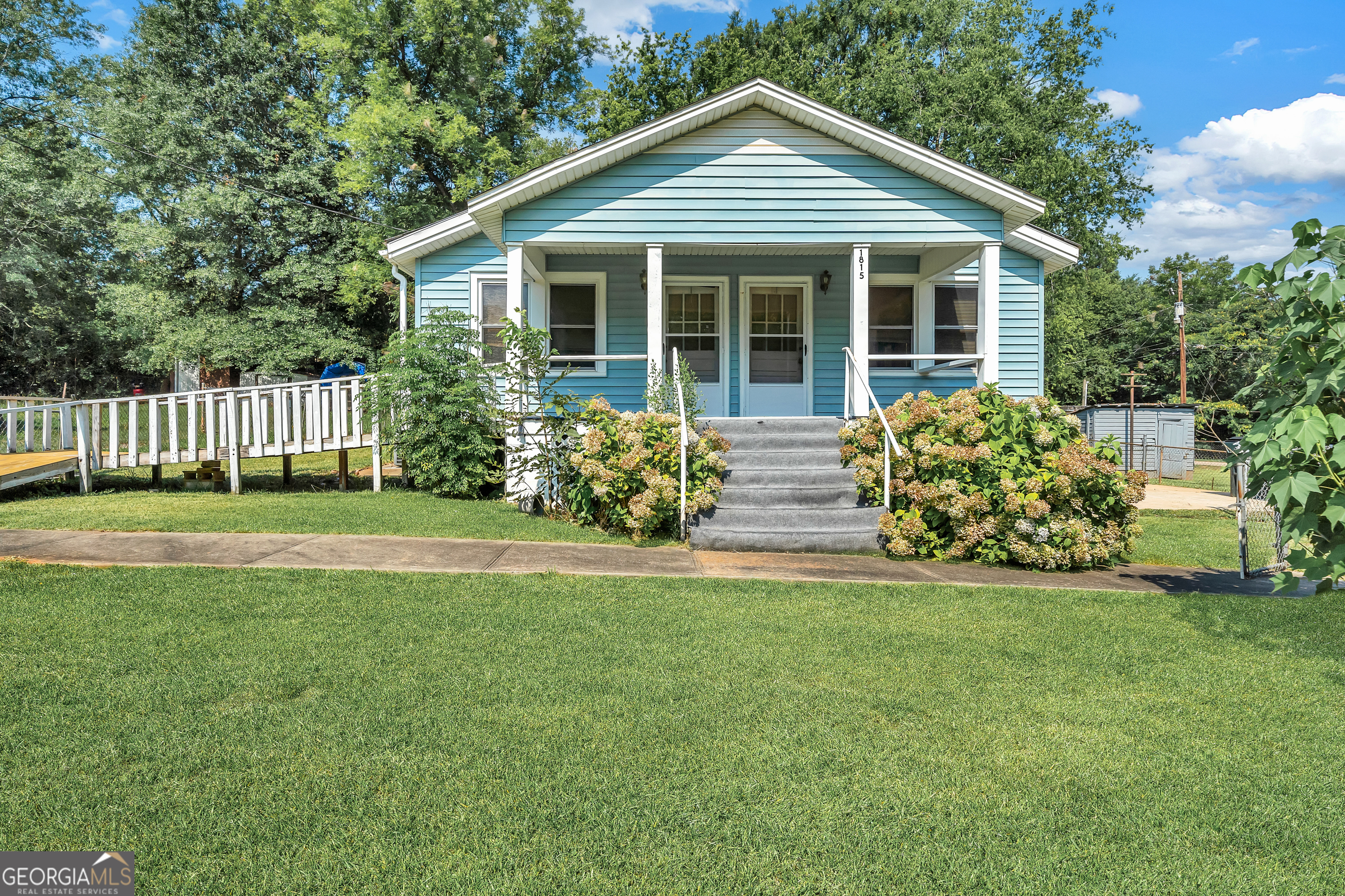 a front view of a house with a garden