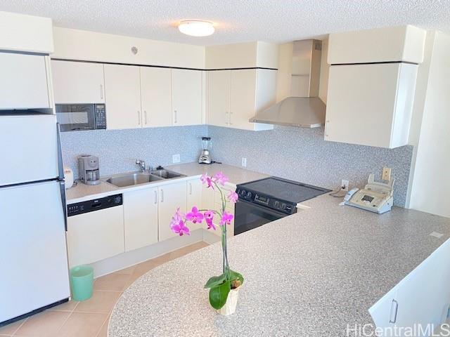 a kitchen with a refrigerator and white cabinets