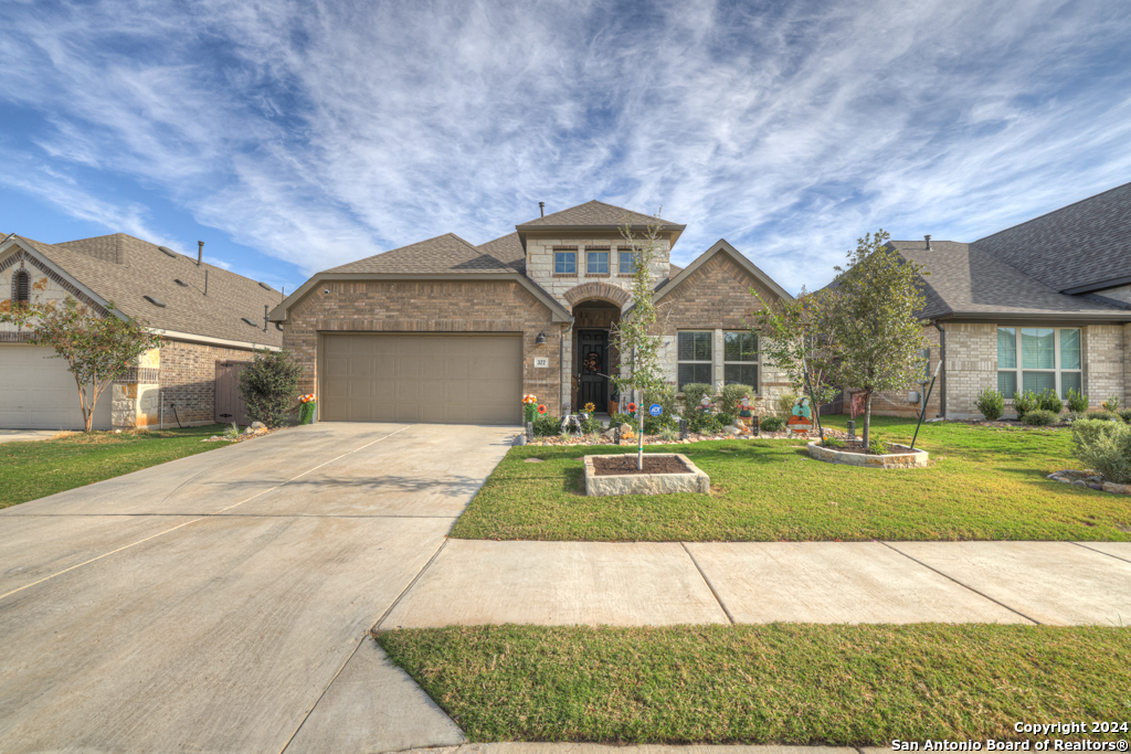 a front view of a house with a yard