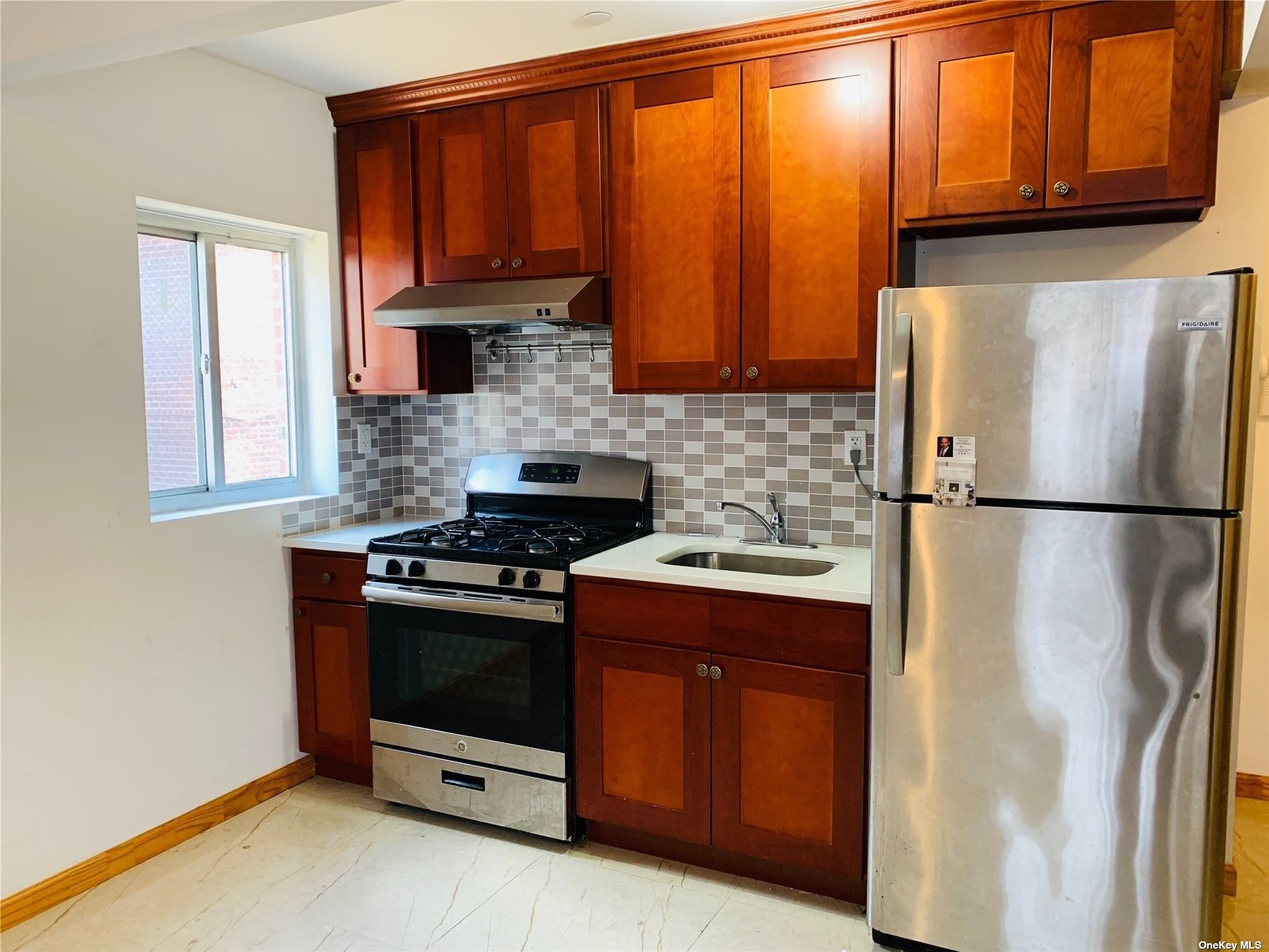 a kitchen with stainless steel appliances granite countertop a stove a refrigerator and a microwave