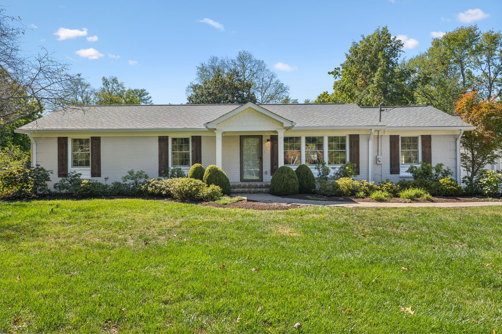 a front view of house with yard and green space