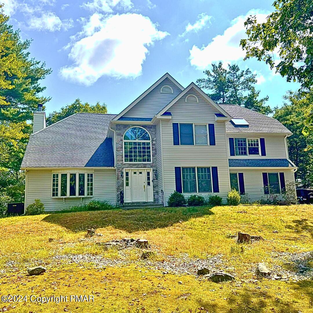 a front view of a house with a yard