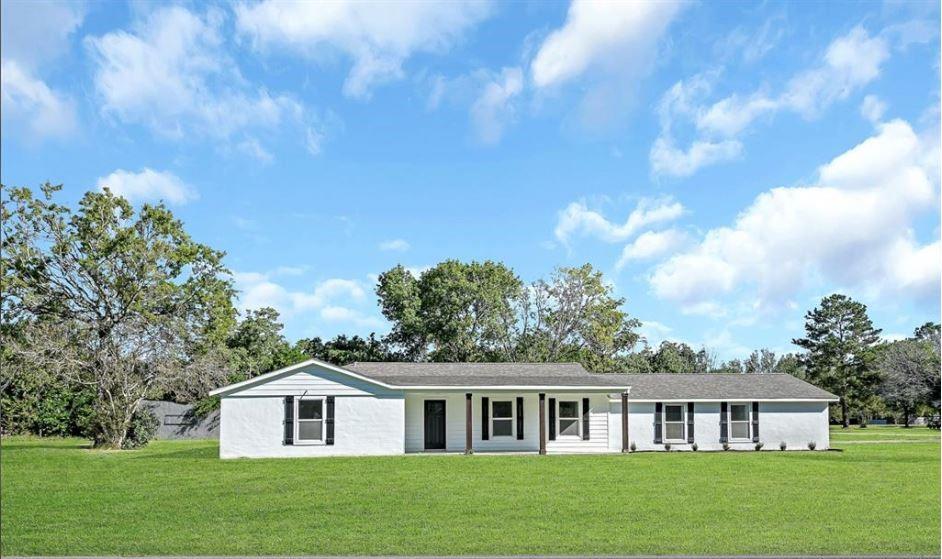 a view of house with yard and green space