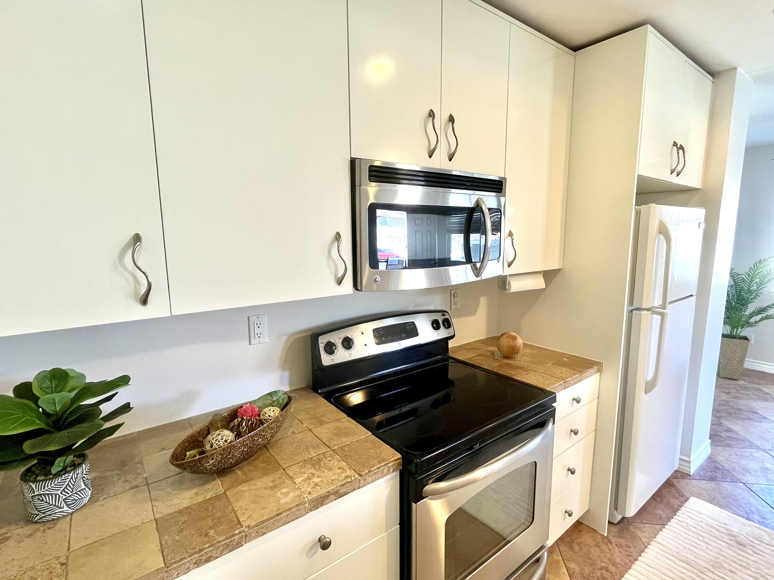 a kitchen with stainless steel appliances a sink a stove and a refrigerator