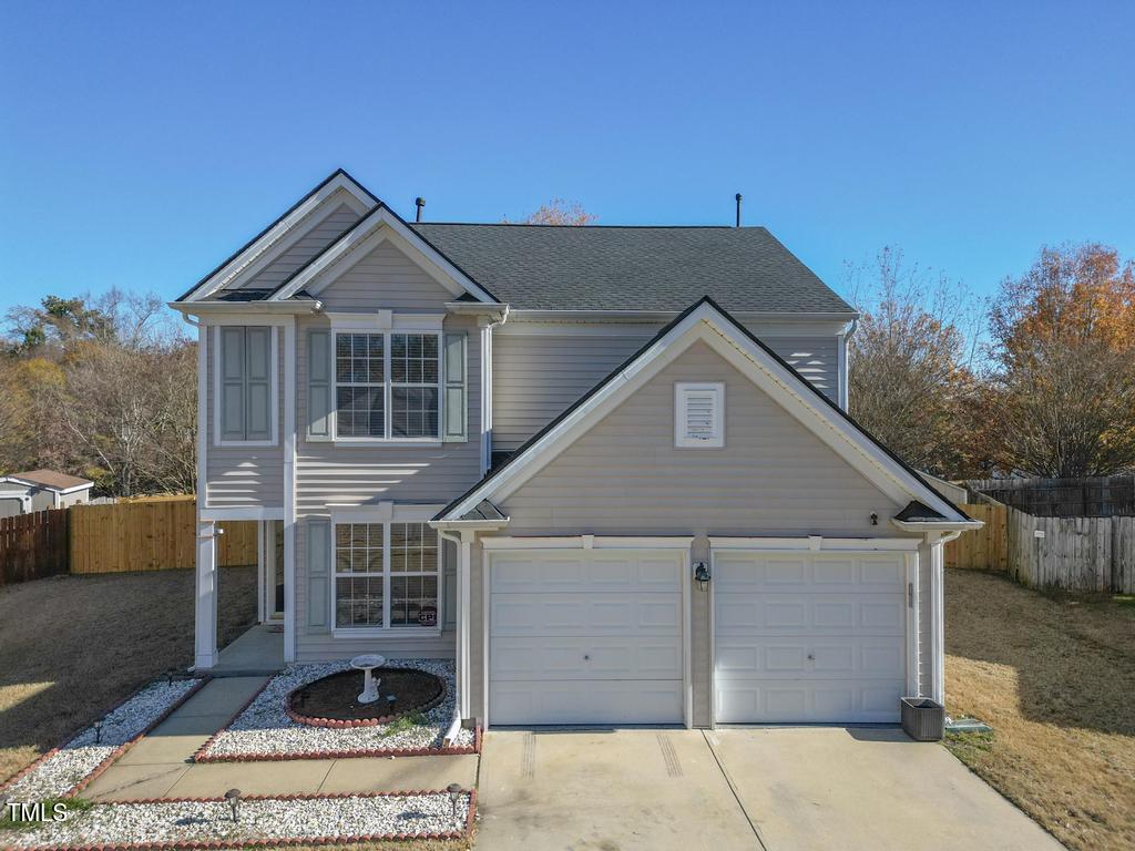 a front view of a house with garage