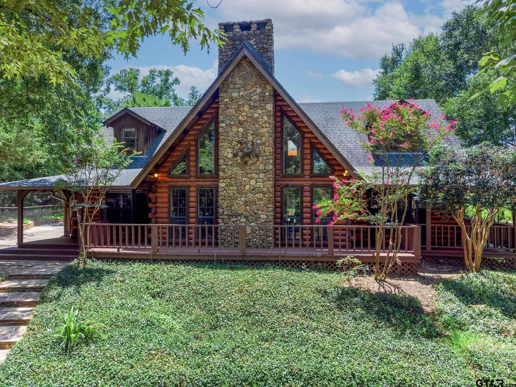 a view of house with a yard and sitting area