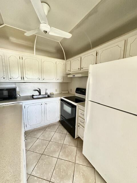 a kitchen with stainless steel appliances a refrigerator sink and cabinets