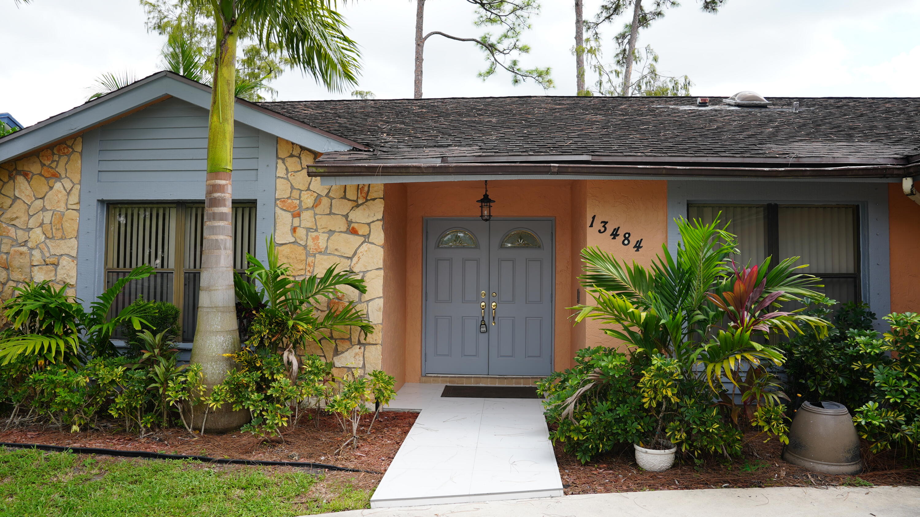 a front view of a house with garden