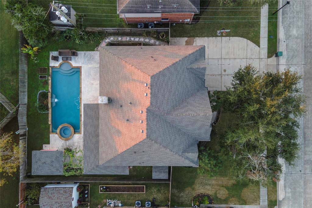 an aerial view of a house with a yard and a fountain