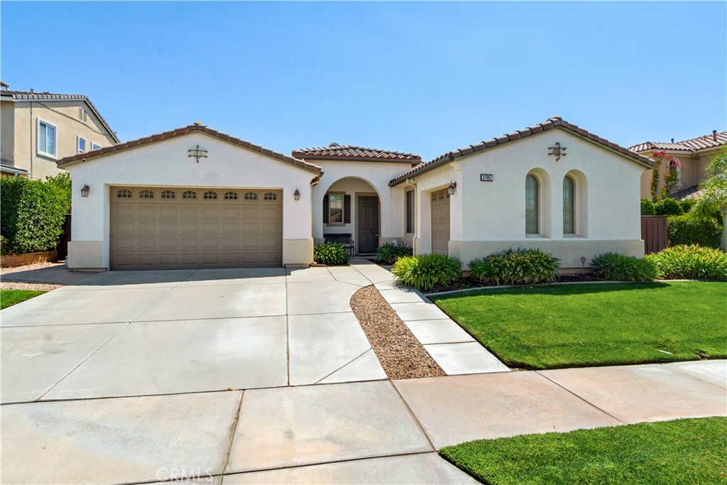 a front view of a house with a yard and garage