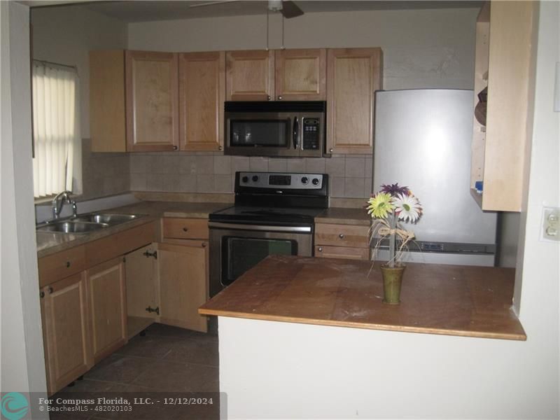 a kitchen with a sink a stove and refrigerator