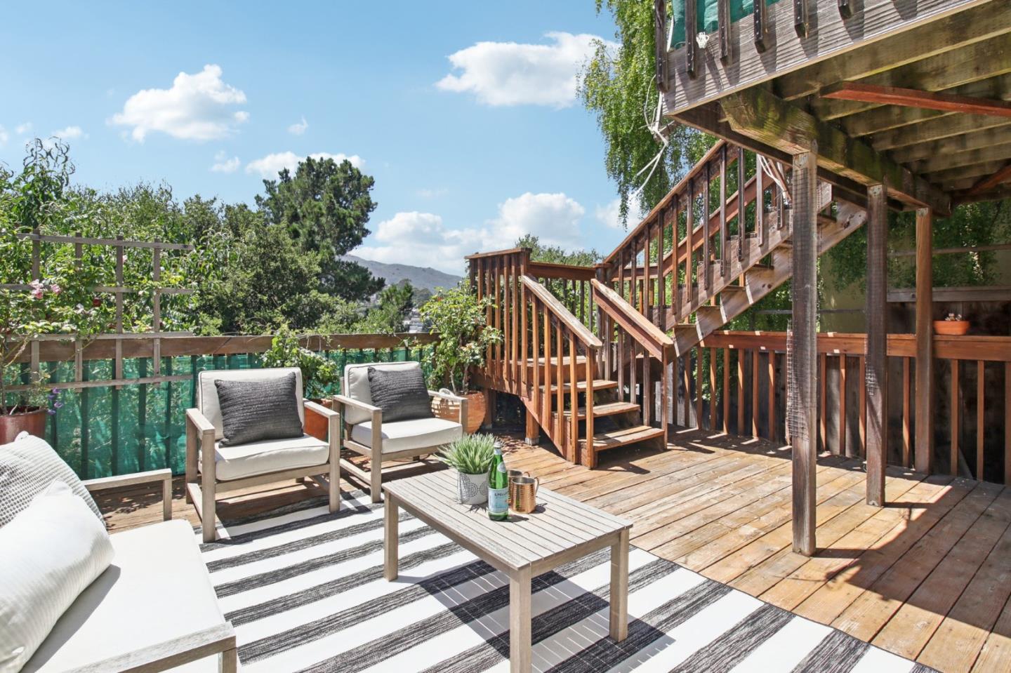 a view of a deck with couches table and chairs