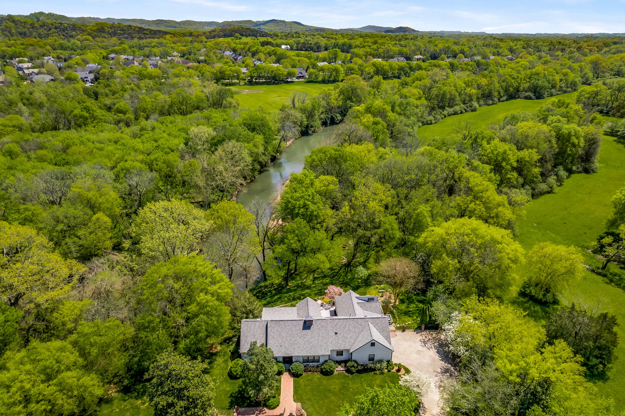 an aerial view of a house with a yard