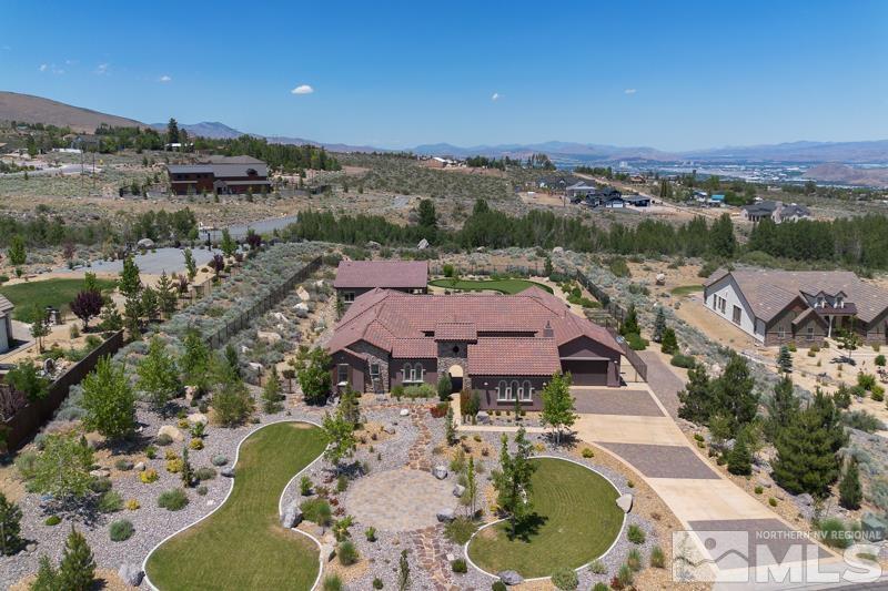 an aerial view of a house with a swimming pool outdoor seating and yard