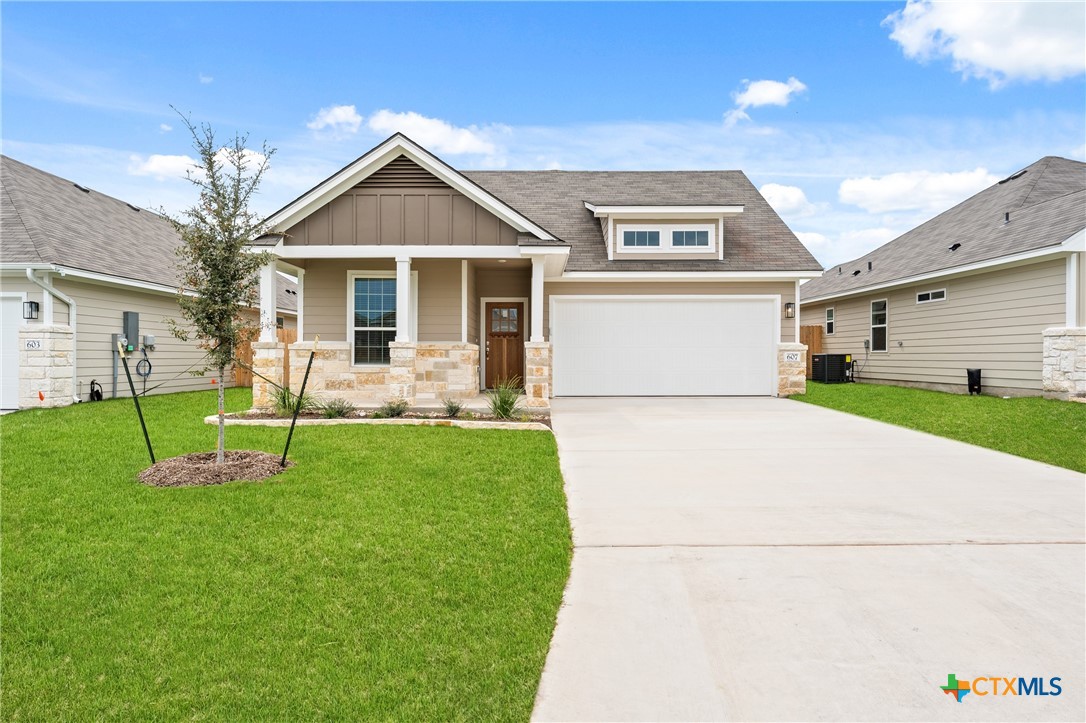 a front view of a house with a yard and garage