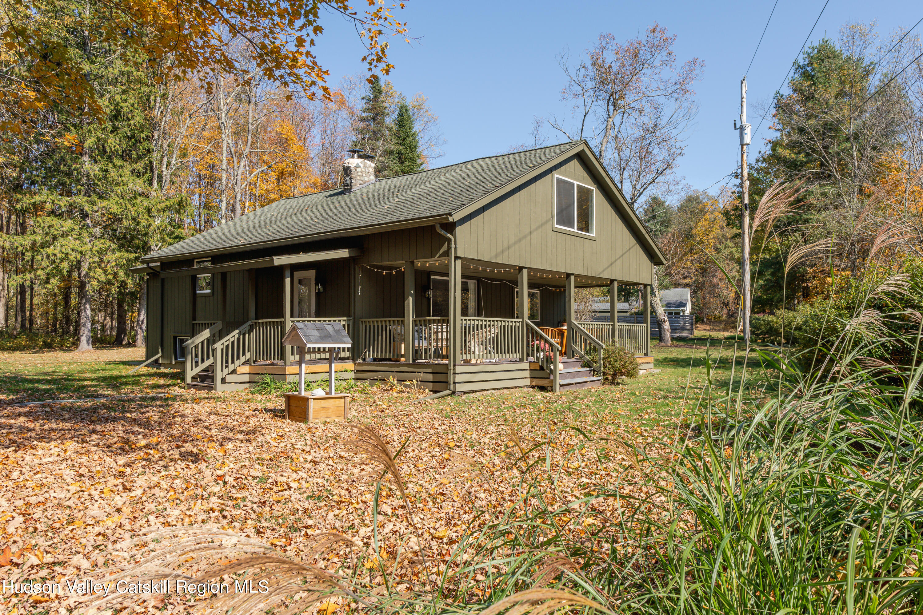 a view of house with backyard and tree