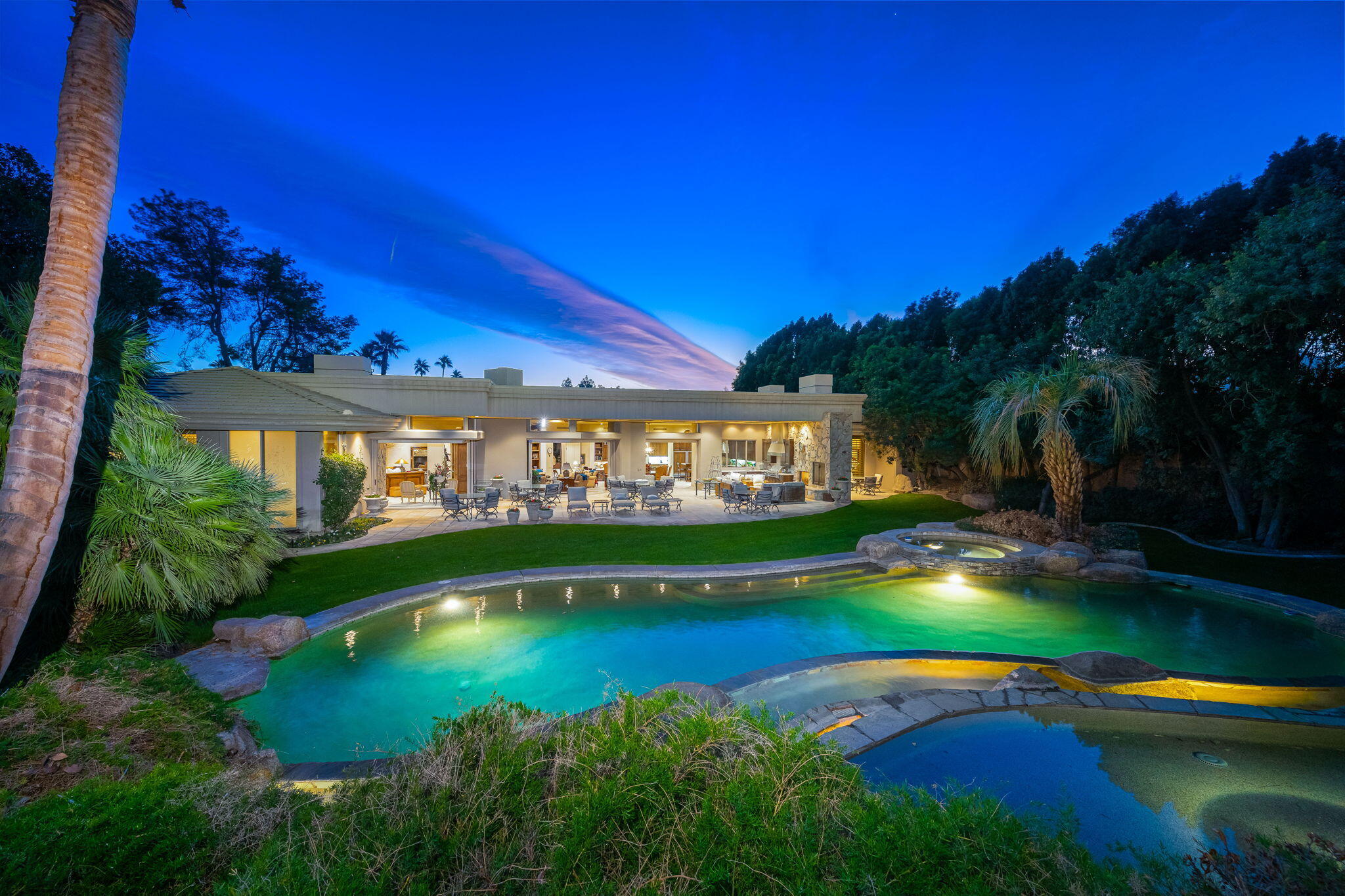 a view of a swimming pool with an outdoor space and seating area