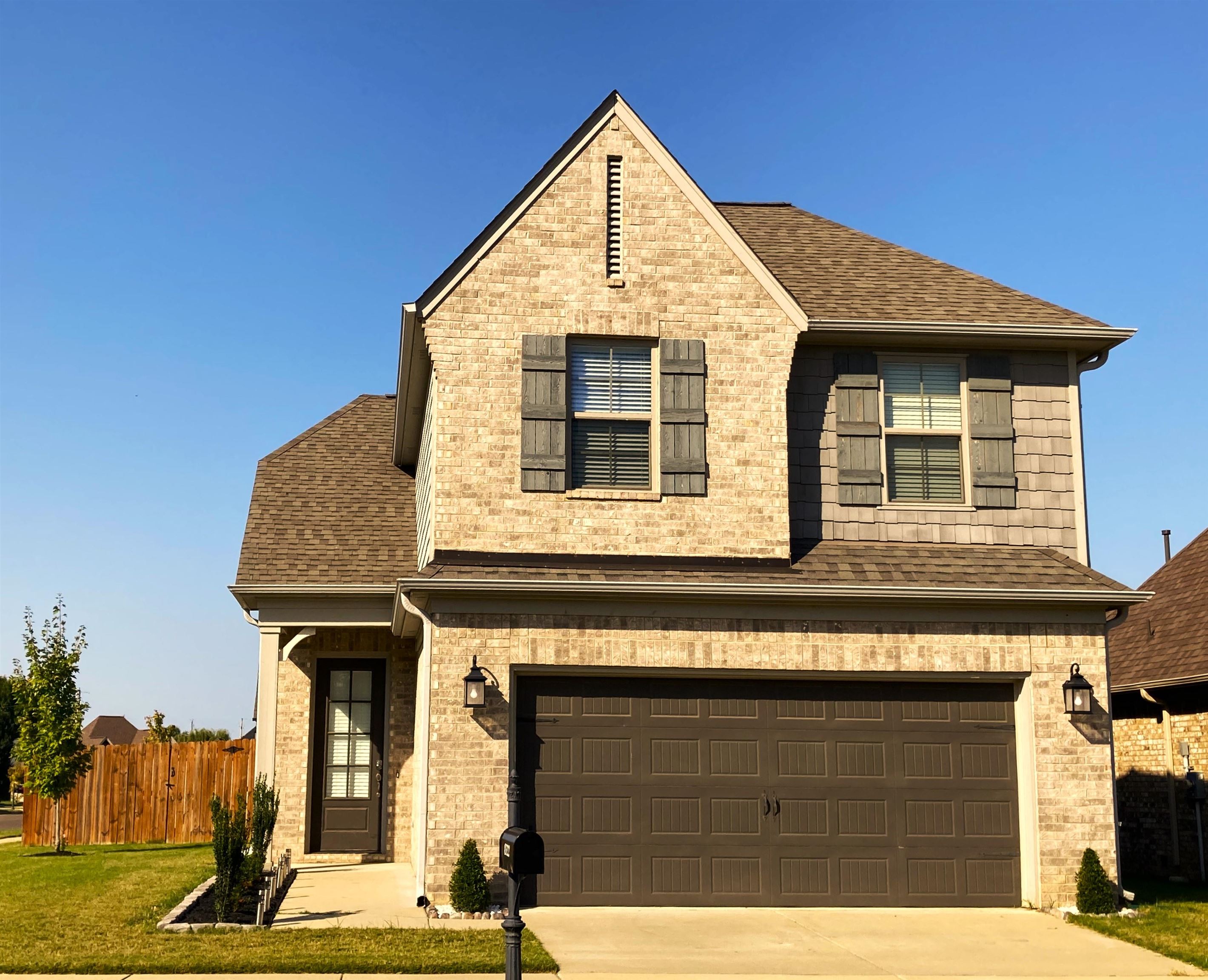 View of front of house featuring a garage and a front yard