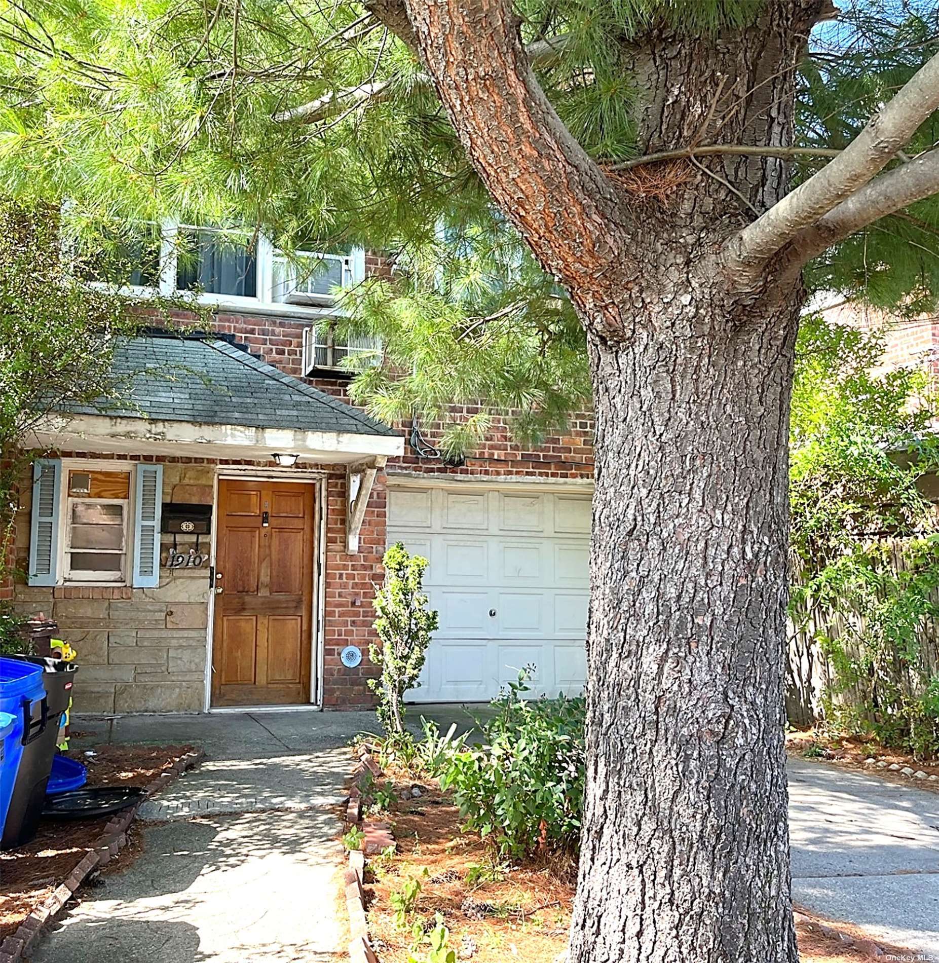 a view of a house with a tree in front