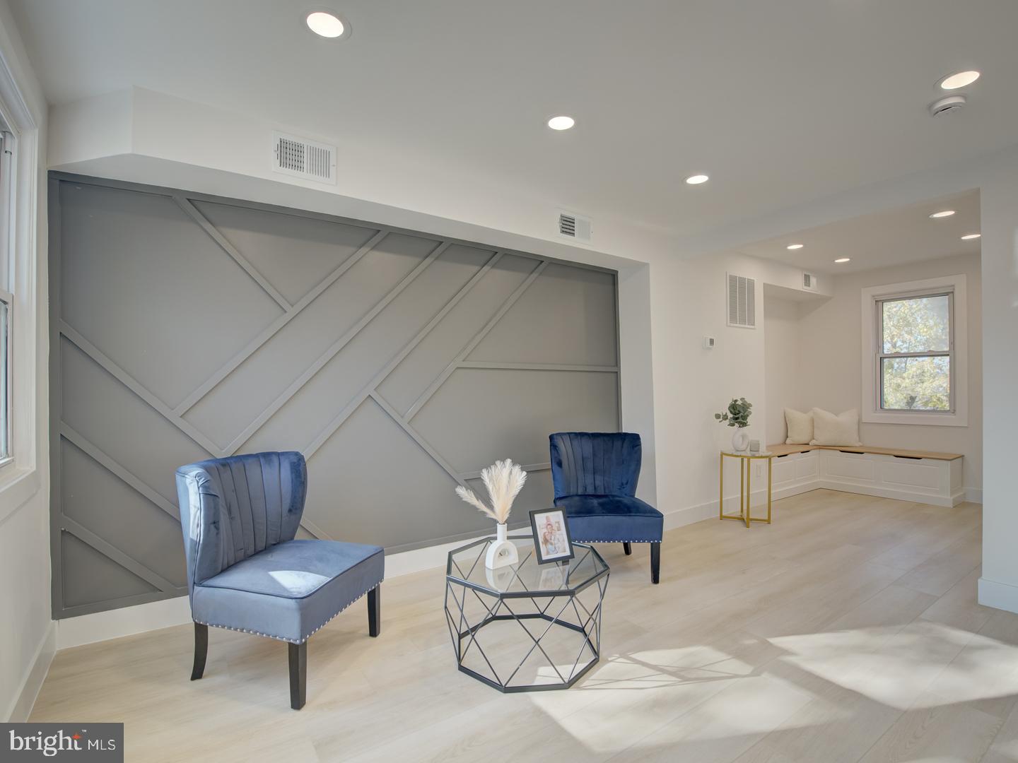 a living room with furniture and a chair