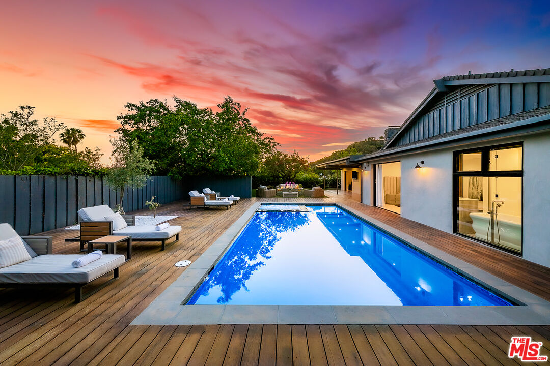 a view of swimming pool with seating area