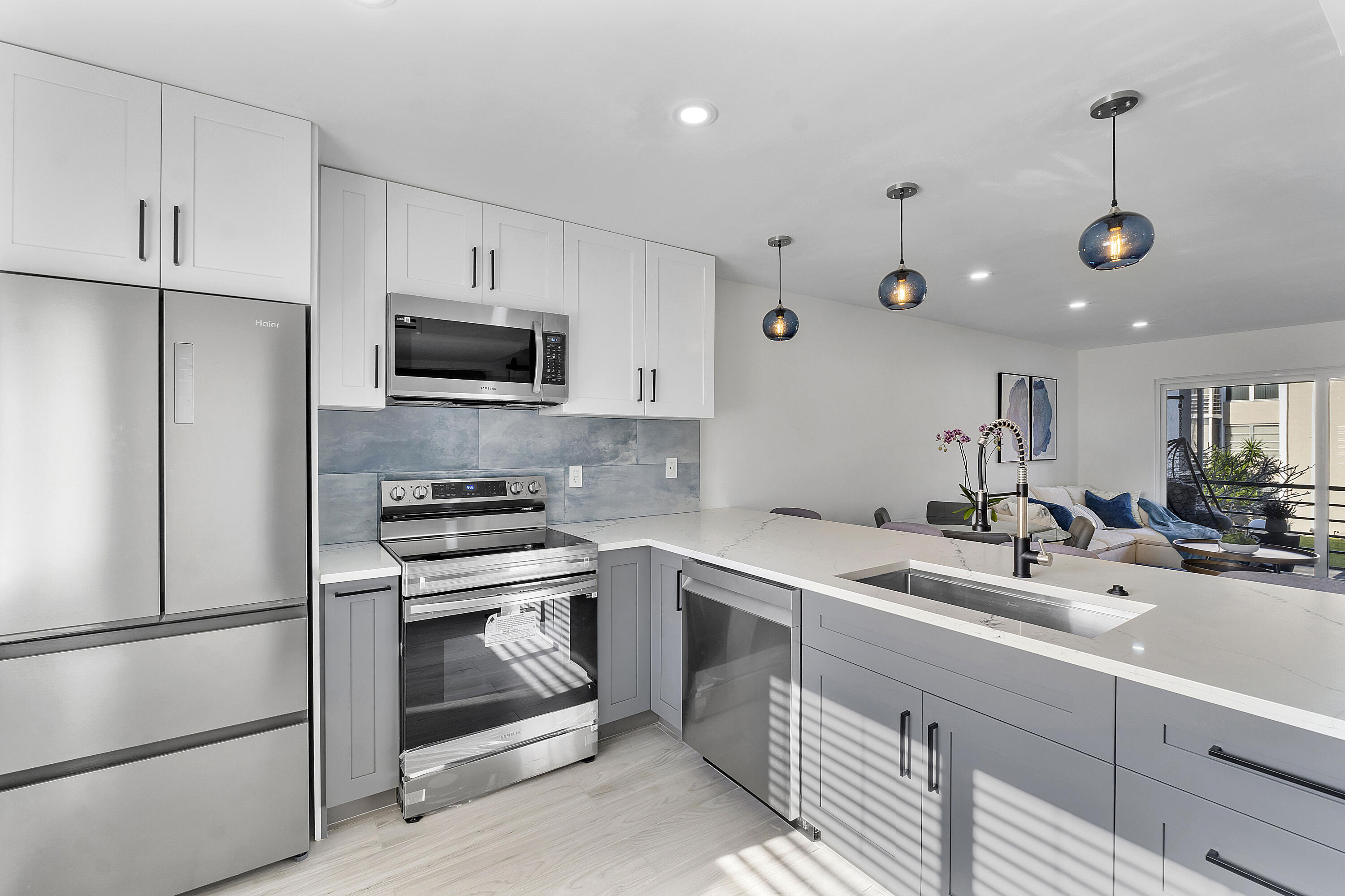 a kitchen with a sink appliances and cabinets