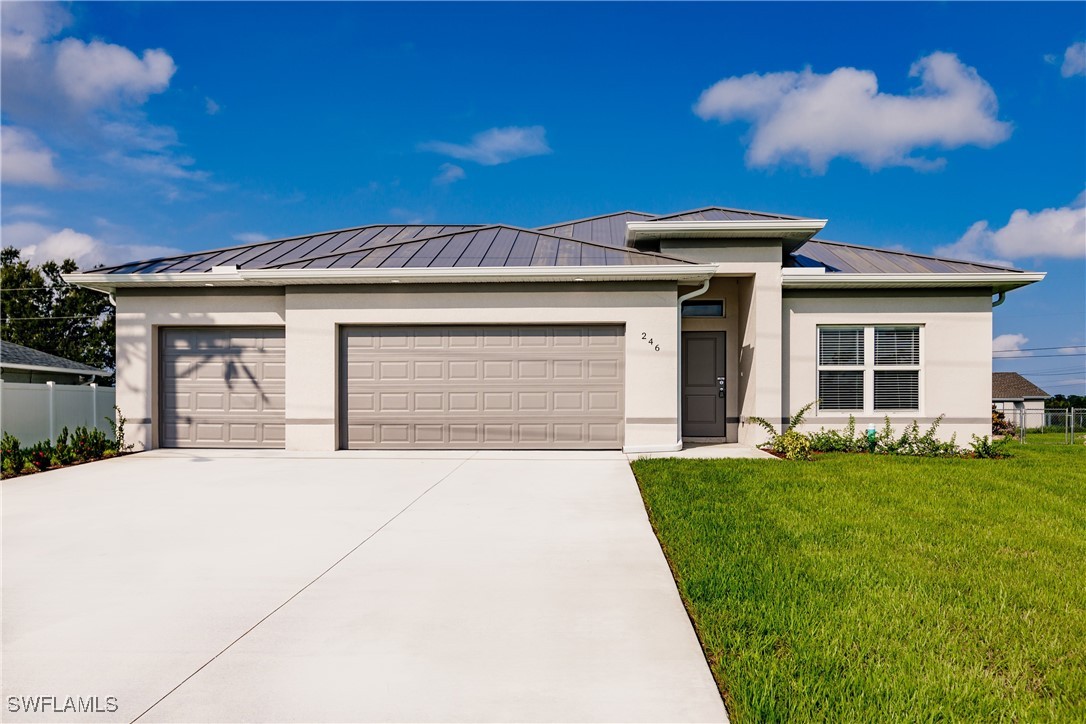 a front view of a house with a garden