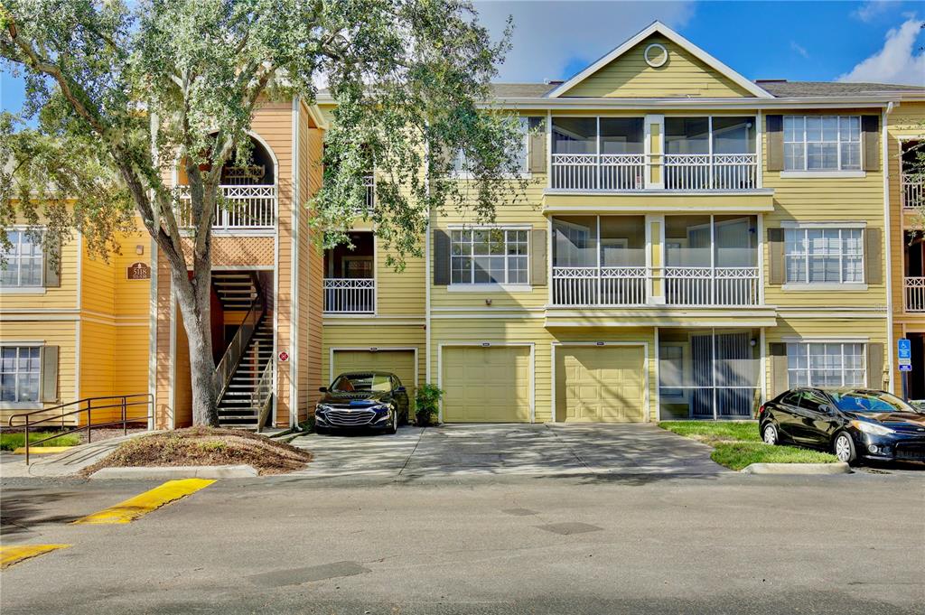 a front view of a residential apartment building with a yard