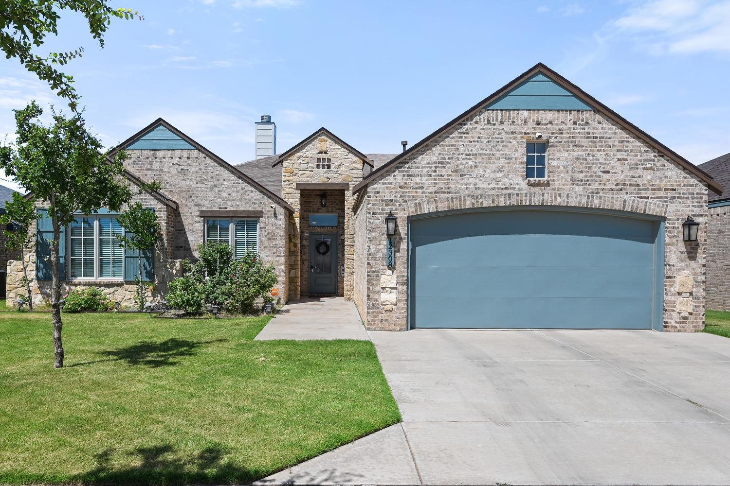 a view of a house with a yard and garage