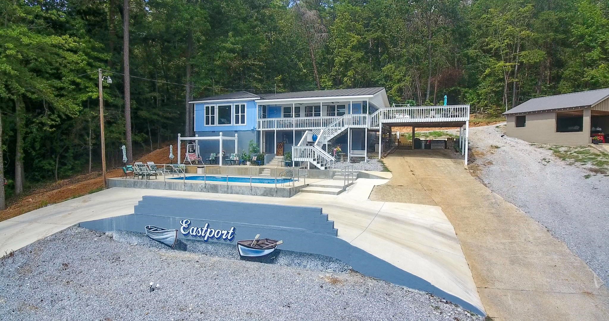 a view of a house with pool and sitting area