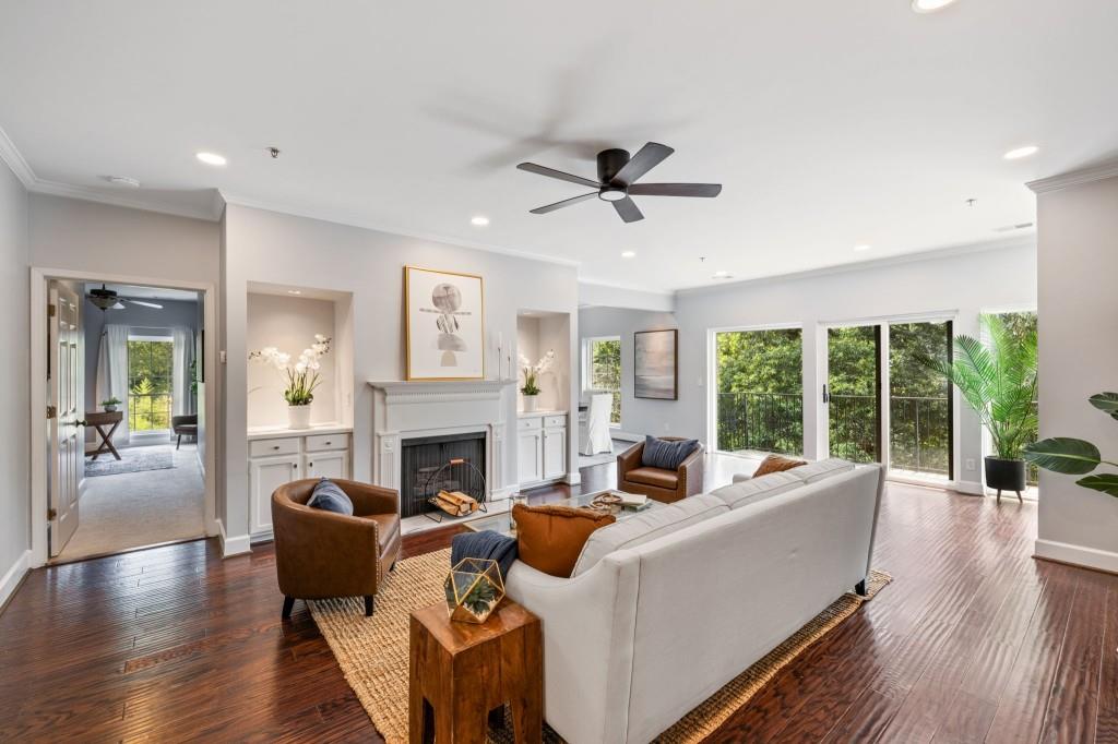 a living room with furniture fireplace and a large window