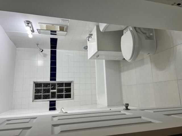 a bathroom with a toilet sink and shower