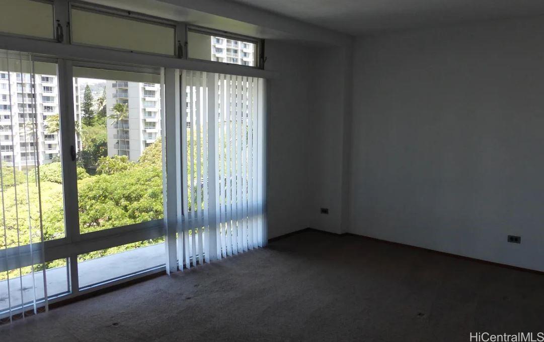 a view of empty room with floor to ceiling window