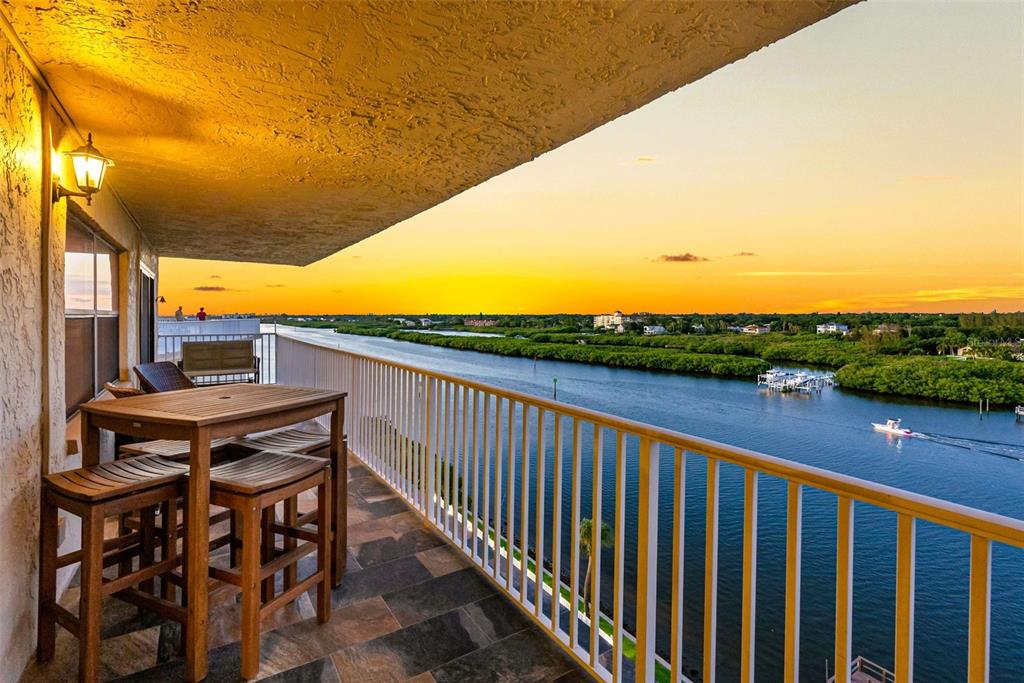 a view of a balcony with furniture and city view