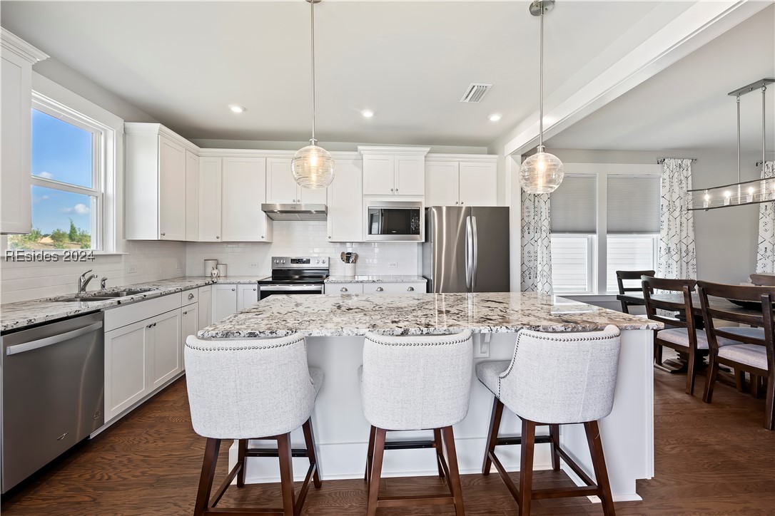 Kitchen with a center island, sink, stainless stee