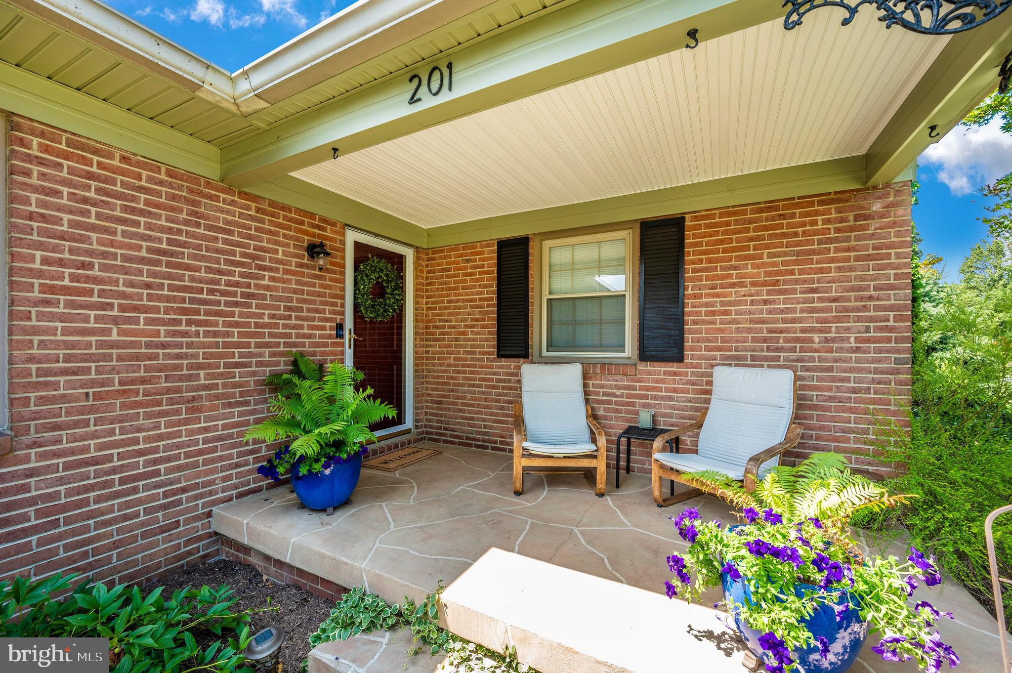 a front view of a house with an outdoor seating