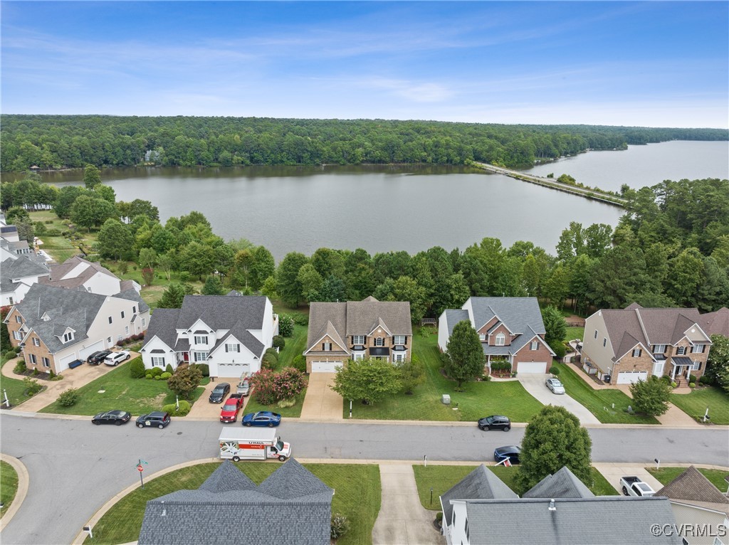 an aerial view of a house with a lake view