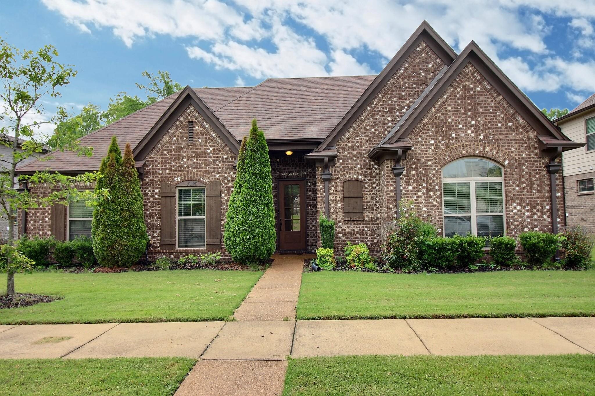 a front view of a house with a yard