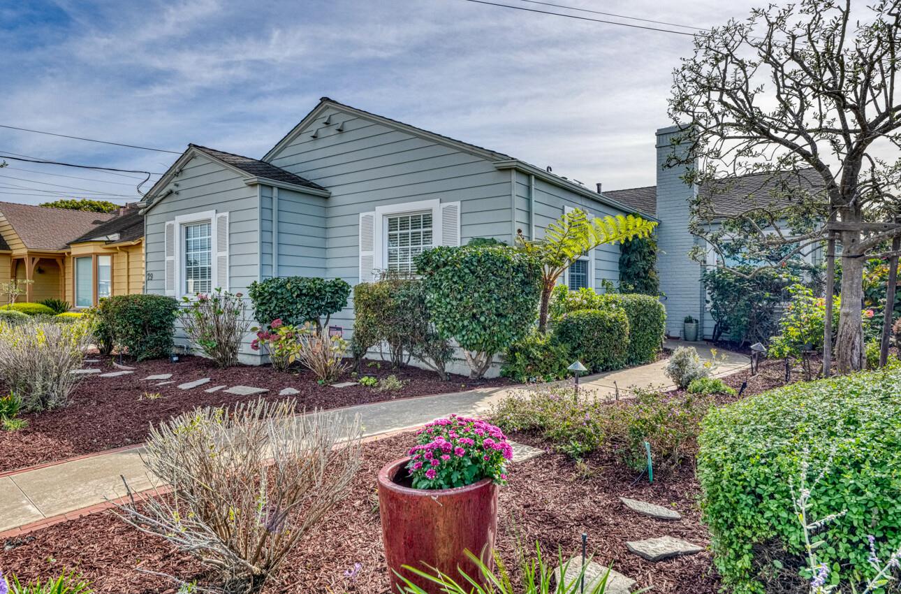 a front view of a house with a yard and outdoor seating