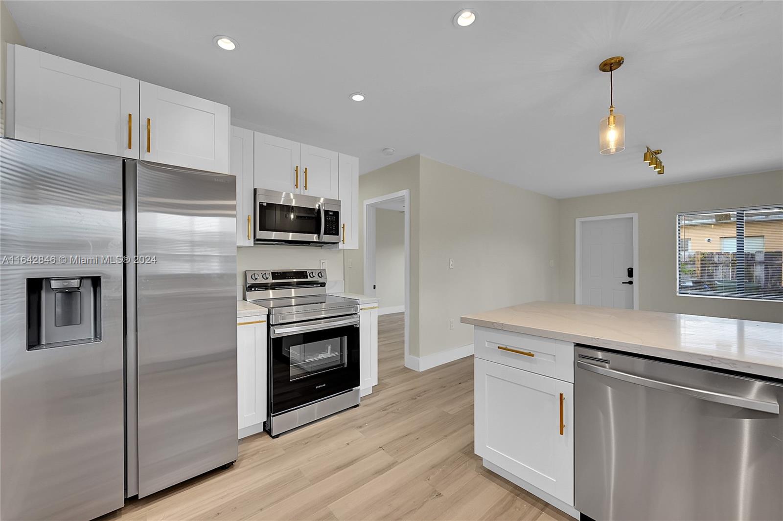 a kitchen with a sink stainless steel appliances and cabinets